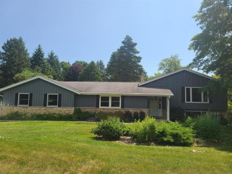 A house with a lot of green grass in front