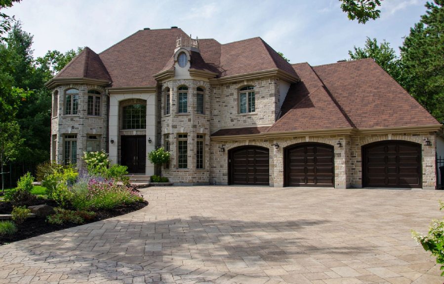 A large brick house with two garage doors.